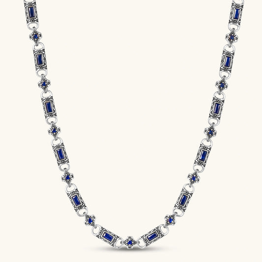 Antique silver plated eco-brass link necklace with blue baguette and round cubic zirconia in ornate scrollwork settings.