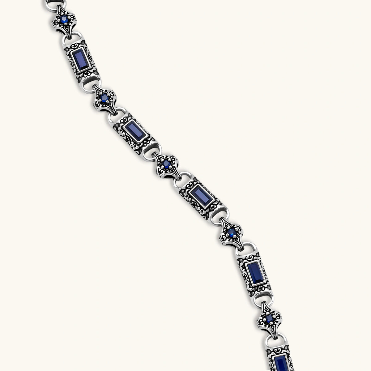 Antique silver plated eco-brass link necklace with blue baguette and round cubic zirconia in ornate scrollwork settings.