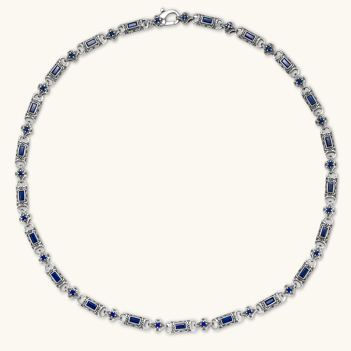 Antique silver plated eco-brass link necklace with blue baguette and round cubic zirconia in ornate scrollwork settings.